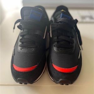 Bold black and red Puma Rider sneakers, striking style in every step.